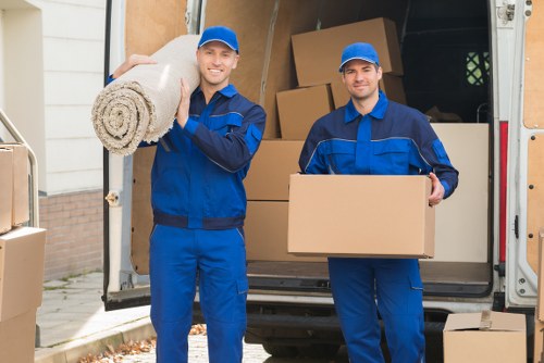 House movers carrying furniture through a central London property