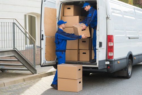 Removal team handling boxed belongings and furniture for a central London move