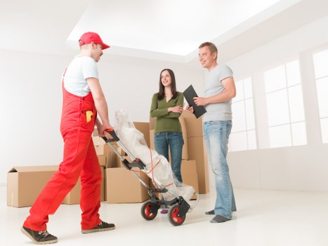 Professional packers preparing fragile household items in Mayfair